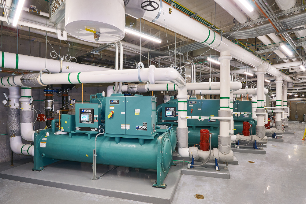 Healthcare construction project showing mechanical installation in an occupied hospital environment with safety protocols